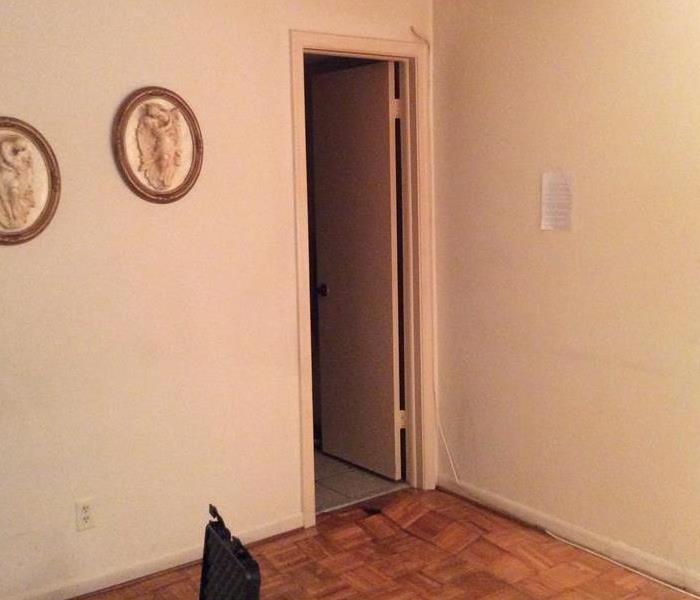 Room with wood floors and a doorway. 