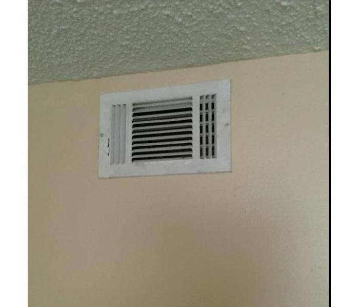 White air vent on a cream colored wall