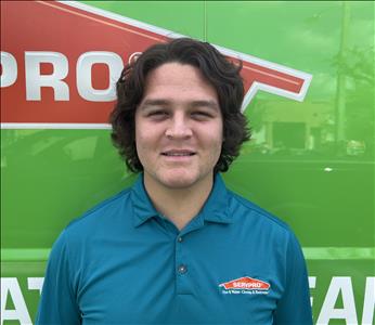 Male with polo shirt in from of SERVPRO Logo