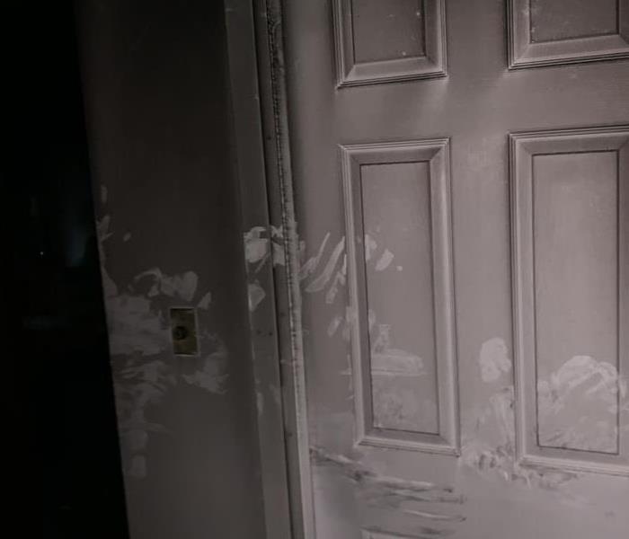 white door covered in soot. 
