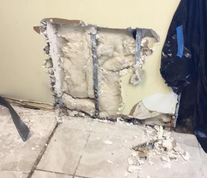 Wall cut made exposing insulation. 