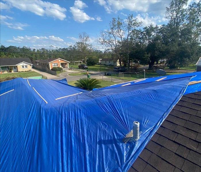 Blue tarp on roof.