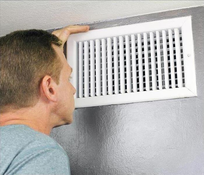 Man looking at a vent